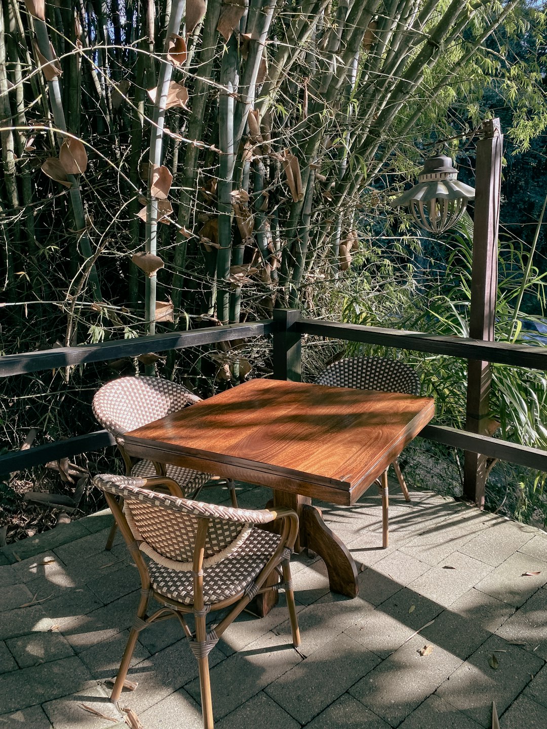 about-us a-wooden-table-sitting-on-top-of-a-wooden-deck-fh5thay06tg
