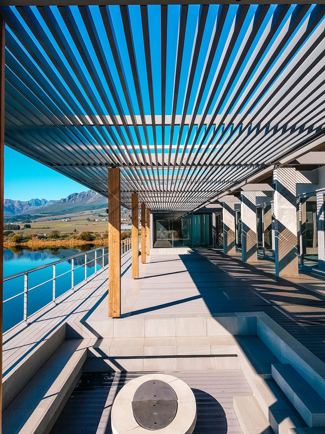a-walkway-with-a-bench-under-a-metal-roof-1dldbl7eisa